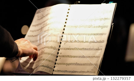 Musician turning music sheet on stage 132279357