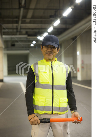 地下駐車場で誘導する男性 132280083