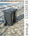 Trash and Recycling Bins Placed Along a Waterfront Promenade in Bright Daylight 132280536
