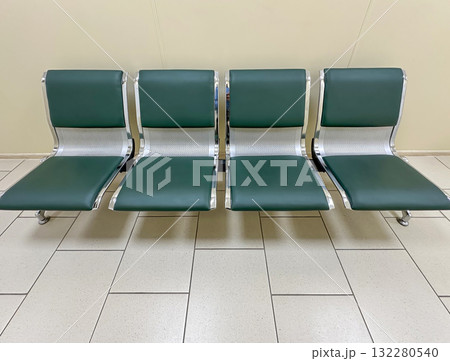 Empty Waiting Area With Green Chairs in a Quiet Airport Terminal Empty Waiting Area With Green Chairs in a Quiet Airport Terminal 132280540