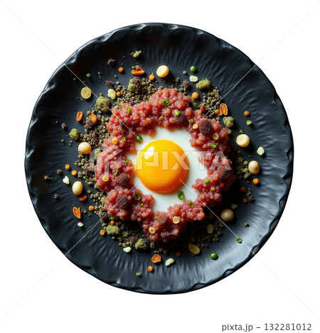 Elegant Pheasant Tartare appetizer with raw egg yolk on black plate. delicious gourmet fine dining dish Elegant Pheasant Tartare appetizer with raw egg yolk on black plate. delicious gourmet fine dining dish 132281012