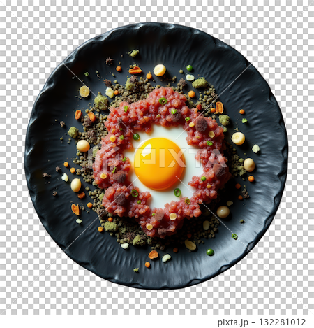 Elegant Pheasant Tartare appetizer with raw egg yolk on black plate. delicious gourmet fine dining dish Elegant Pheasant Tartare appetizer with raw egg yolk on black plate. delicious gourmet fine dining dish 132281012