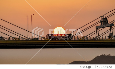 Oct 7 2025 Sunset Over Bridge With Silhouetted Bus, Cables, And Industrial Structures 132282528