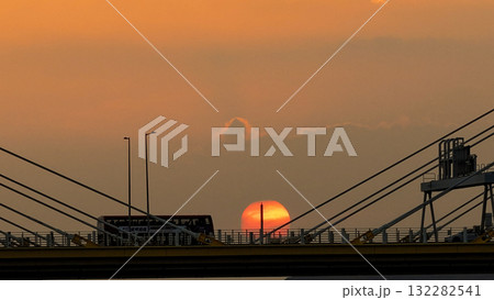 Oct 7 2025 Sunset Over Bridge With Silhouetted Bus, Cables, And Industrial Structures 132282541