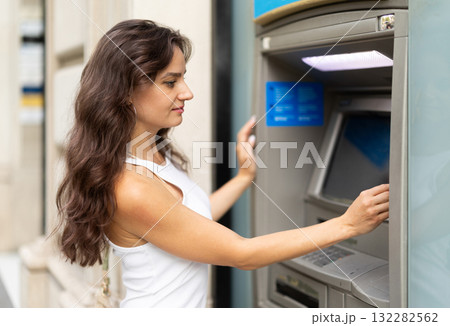 Young woman enters her ATM PIN code 132282562