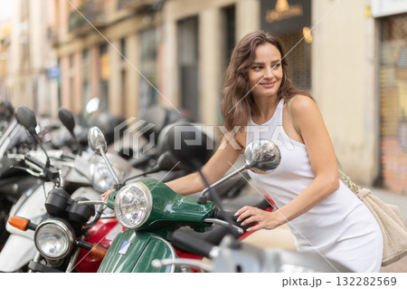 Young woman rents bike on city street Young woman rents bike on city street 132282569