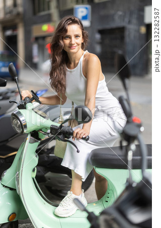Young woman rents bike on city street Young woman rents bike on city street 132282587