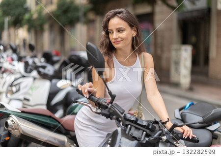 Young woman rents bike on city street Young woman rents bike on city street 132282599