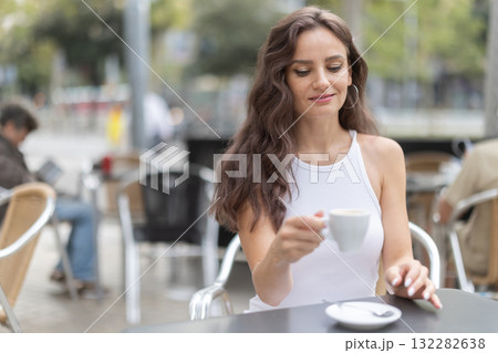 Young woman drinking coffee in cafe 132282638