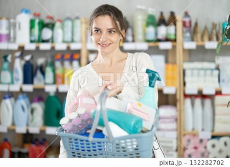 Young woman chooses household chemicals in store Young woman chooses household chemicals in store 132282702