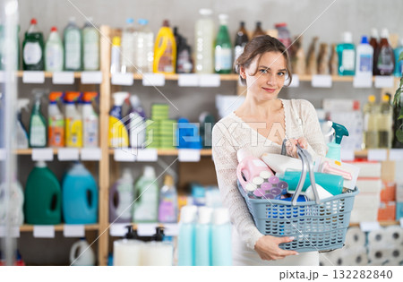Young woman chooses household chemicals in store Young woman chooses household chemicals in store 132282840