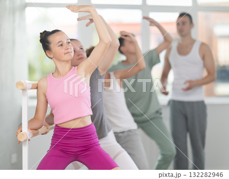 Teenage girl practicing plie position of ballet during choreography classes 132282946