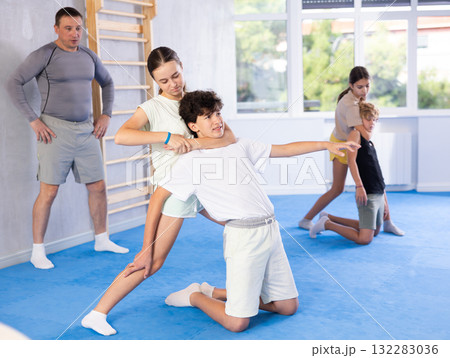 Boy and girl practicing self-defense techniques Boy and girl practicing self-defense techniques 132283036