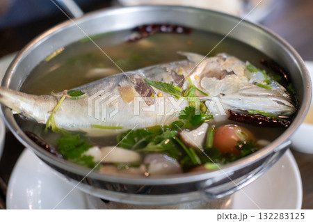 Mackerel tom yum, a spicy and sour Thai soup featuring mackerel, herbs, and aromatic spices. Mackerel tom yum, a spicy and sour Thai soup featuring mackerel, herbs, and aromatic spices. 132283125