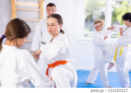 Two girls training karate techniques in studio 132283127