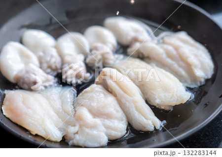 Raw sea bass meat on plate, prepared for hot pot Raw sea bass meat on plate, prepared for hot pot 132283144