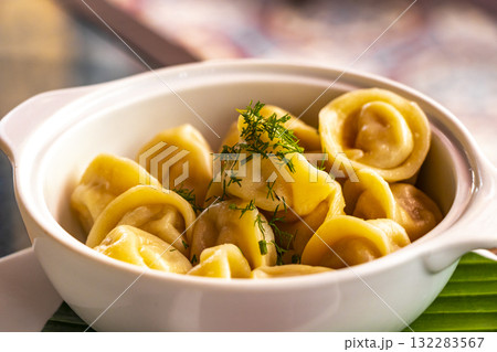 Russian pelmeni in a white plate bowl on Phuket Thailand. Russian pelmeni in a white plate bowl on Phuket Thailand. 132283567