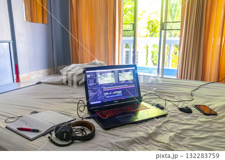 Laptop on the bed in tropical apartment hotel room Thailand. Laptop on the bed in tropical apartment hotel room Thailand. 132283759