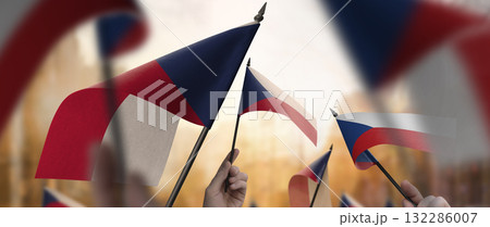 Czechia flags in their hands on a blurred urban background 132286007