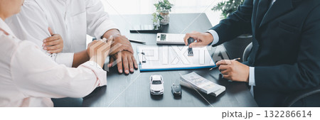Panorama of car loan approval with businessman stamping contract, cash, vehicle model and key on desk, concept of finance, insurance, leasing, trust, confirmation and business deal. car loan approval Panorama of car loan approval with businessman stamping contract, cash, vehicle model and key on desk, concept of finance, insurance, leasing, trust, confirmation and business deal. car loan approval 132286614