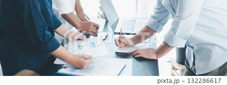 Panorama of corporate teamwork with people discussing financial reports, pointing at charts, planning business strategy, analyzing data and collaborating in office meeting for professional success. Panorama of corporate teamwork with people discussing financial reports, pointing at charts, planning business strategy, analyzing data and collaborating in office meeting for professional success. 132286617