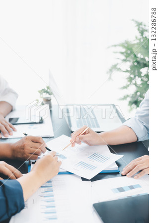 Business teamwork reviewing financial report with charts and graphs in modern office, colleagues discussing analysis, planning strategy, growth and corporate success with documents and technology. 132286788