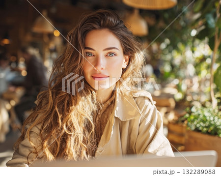Young woman smiling enjoying coffee shop atmosphere 132289088