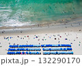 Blue umbrellas with tourists relaxing at Kata beach in Phuket, Thailand. 132290170