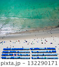 Blue umbrellas with tourists relaxing at Kata beach in Phuket, Thailand. 132290171