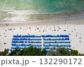 Blue umbrellas with tourists relaxing at Kata beach in Phuket, Thailand. 132290172