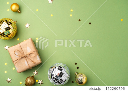 Christmas gift with ornaments on a green background 132290796