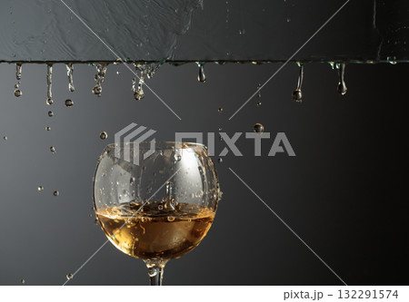 White wine flows down into a glass. White wine flows down into a glass. 132291574