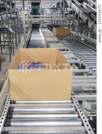 packing line in a logistics warehouse. conveyor belt in a modern production line packing line in a logistics warehouse. conveyor belt in a modern production line 132291672