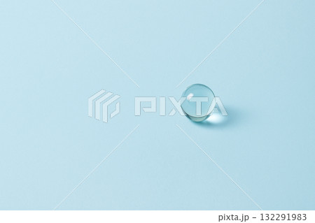 ライトブルーの背景に置かれたガラスのビー玉 132291983
