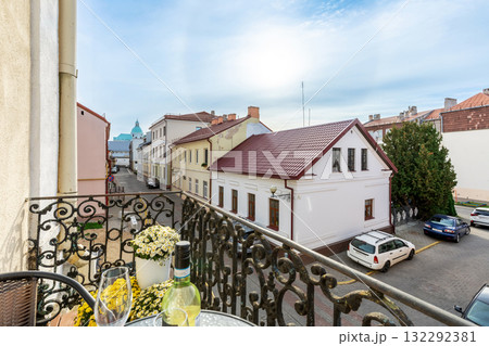 Balcony View of Old Town Street with Wine Bottle and Flowers 132292381
