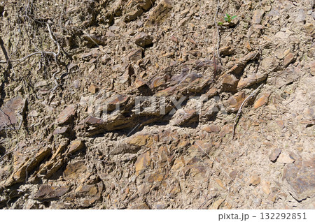 A detailed view of a quarry that is no longer in use. A detailed view of the crumbling remains of stone quarrying. A detailed view of a quarry that is no longer in use. A detailed view of the crumbling remains of stone quarrying. 132292851