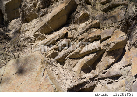 A detailed view of a quarry that is no longer in use. A detailed view of the crumbling remains of stone quarrying. A detailed view of a quarry that is no longer in use. A detailed view of the crumbling remains of stone quarrying. 132292853