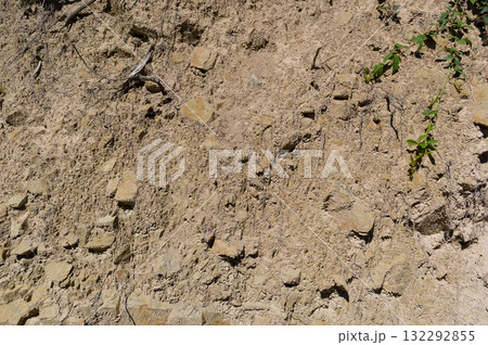 A detailed view of a quarry that is no longer in use. A detailed view of the crumbling remains of stone quarrying. A detailed view of a quarry that is no longer in use. A detailed view of the crumbling remains of stone quarrying. 132292855