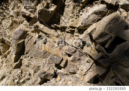 A detailed view of a quarry that is no longer in use. A detailed view of the crumbling remains of stone quarrying. A detailed view of a quarry that is no longer in use. A detailed view of the crumbling remains of stone quarrying. 132292880