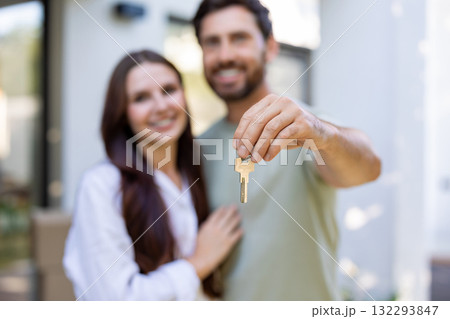 Happy couple looking excited while moving to a new house Happy couple looking excited while moving to a new house 132293847