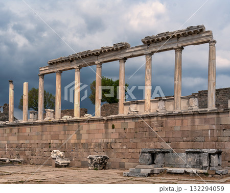 Temple of Trajan ruins with ancient Roman columns, Pergamon Acropolis, Bergama, Izmir, Turkey under cloudy sky 132294059