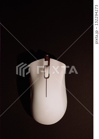 White wired gaming mouse on dark background top view White wired gaming mouse on dark background top view 132294273