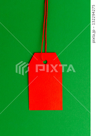 Red price tag on green background minimal composition 132294275
