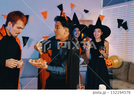 Joyful office Halloween party with coworkers in costumes, celebrating with drinks and laughter, fostering teamwork and festive spirit 132294576