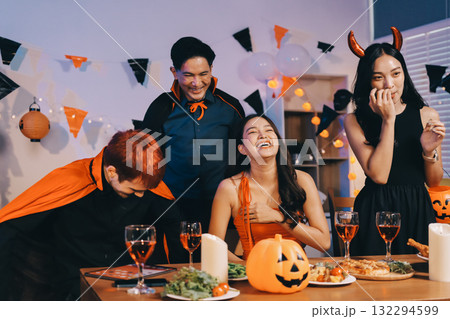 Joyful office Halloween party with coworkers in costumes, celebrating with drinks and laughter, fostering teamwork and festive spirit Joyful office Halloween party with coworkers in costumes, celebrating with drinks and laughter, fostering teamwork and festive spirit 132294599