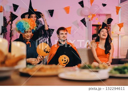Joyful office Halloween party with coworkers in costumes, celebrating with drinks and laughter, fostering teamwork and festive spirit Joyful office Halloween party with coworkers in costumes, celebrating with drinks and laughter, fostering teamwork and festive spirit 132294611