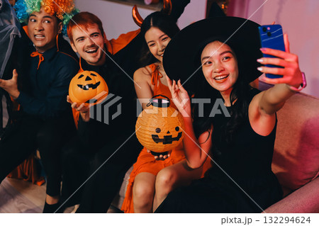 Joyful office Halloween party with coworkers in costumes, celebrating with drinks and laughter, fostering teamwork and festive spirit 132294624