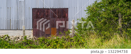 Close-up view of an old industrial building. Abstract background for various uses. Close-up view of an old industrial building. Abstract background for various uses. 132294738