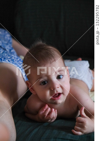 Playful Baby Lying on Bed Playful Baby Lying on Bed 132295782