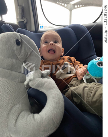 Baby Smiling at Plush Toy Elephant in Car Seat Baby Smiling at Plush Toy Elephant in Car Seat 132295846